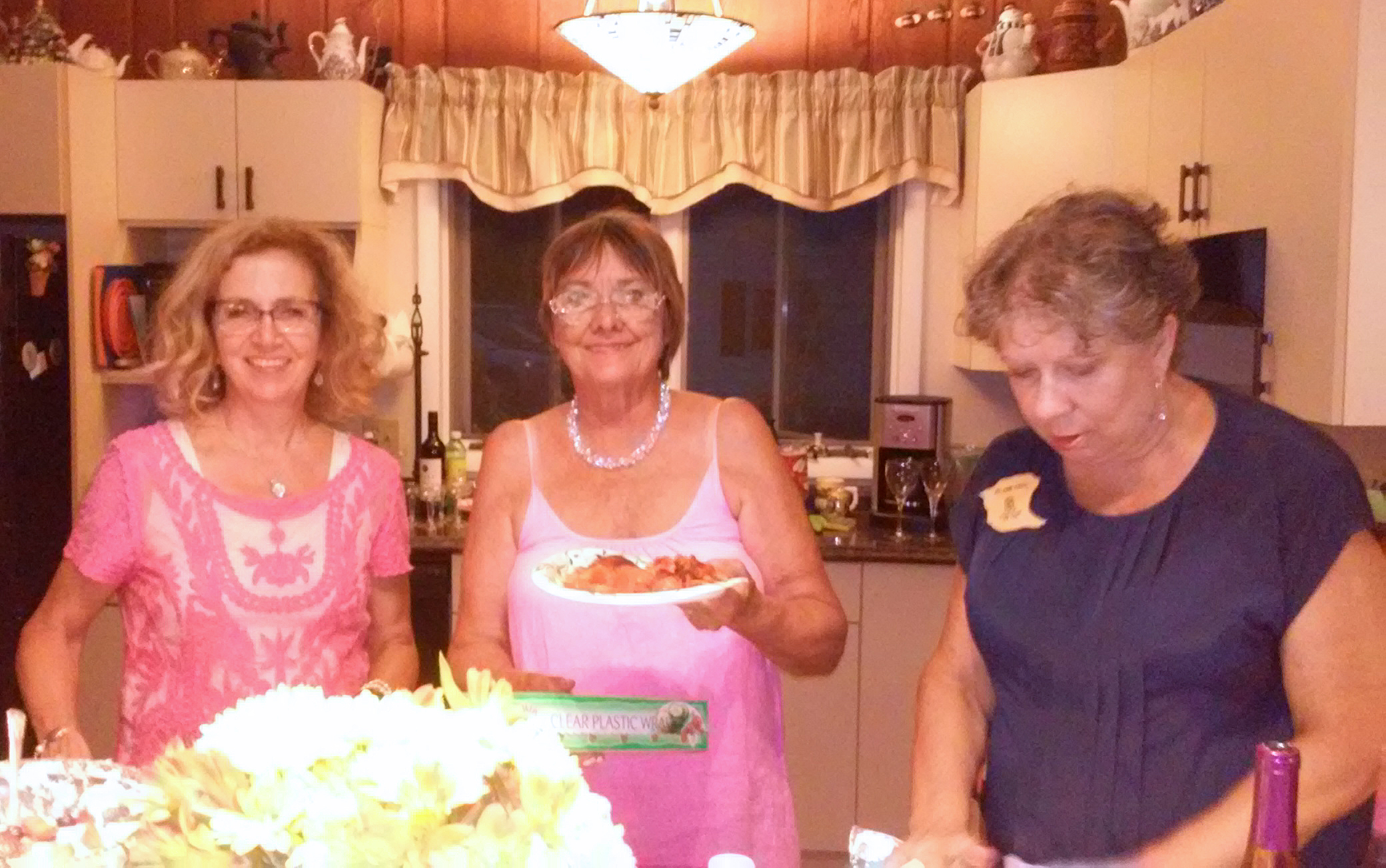 At Zonta's summer picnic, Denise, Linda and JoAnn get a helping of the food catered by McMahon's Family Restaurant.